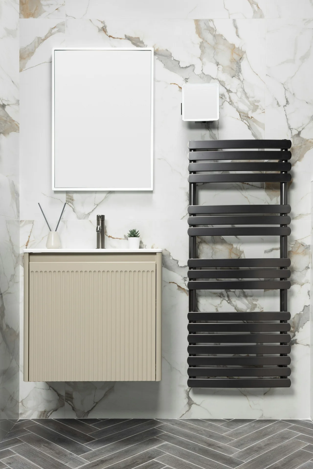 Stock illustration of pale tiled walls, a fluted vanity and a dark towel radiator in a bathroom.