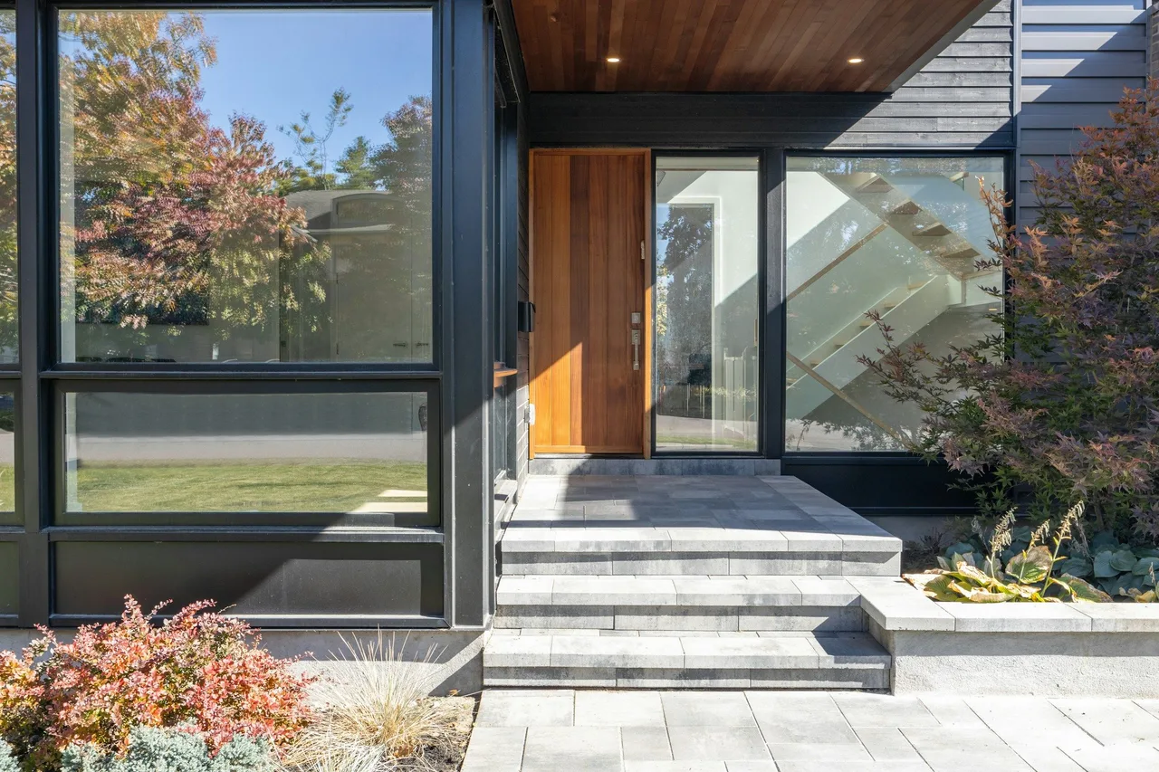 Stock architectural illustration of a contemporary glazed entrance, timber door and stone steps.