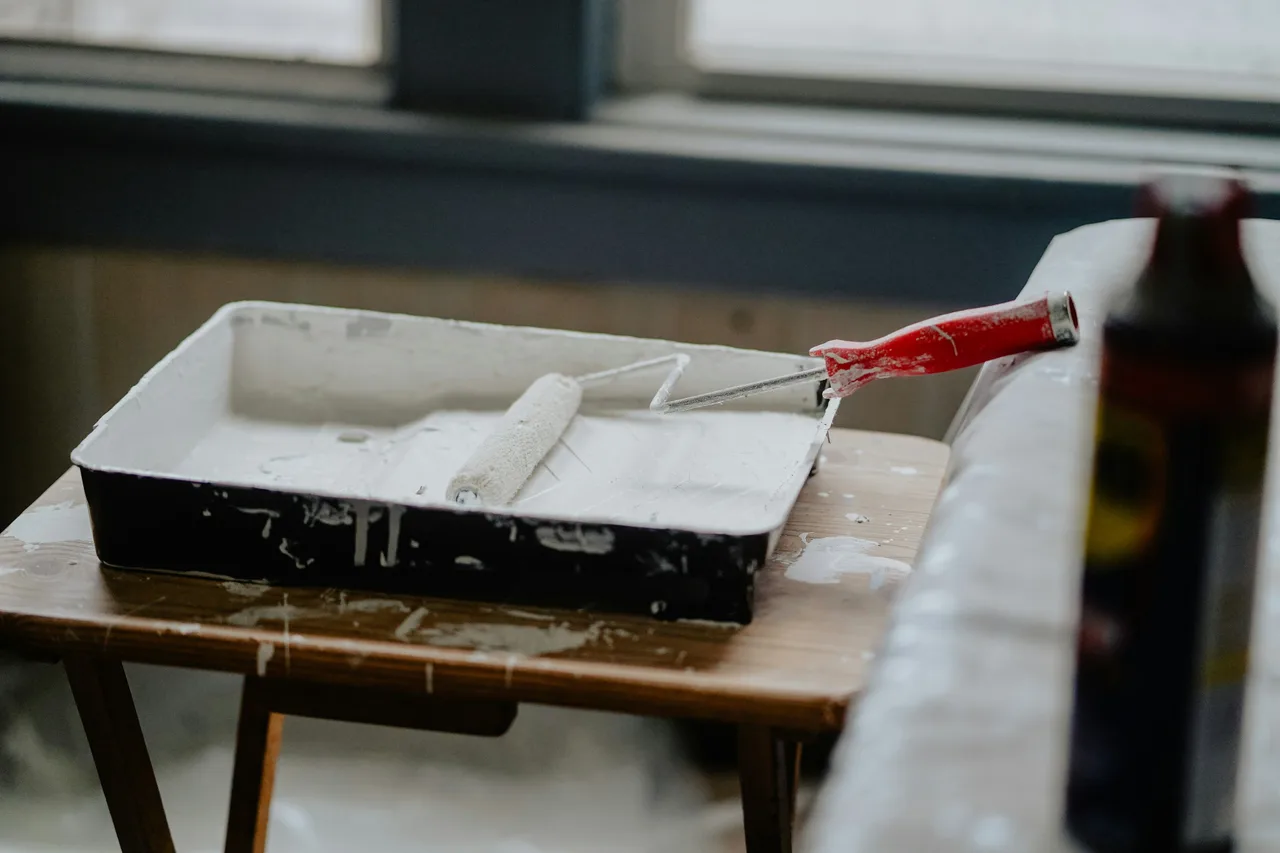 Stock photograph of a paint roller and tray ready for decorating work.